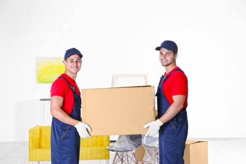 Furniture removals team handling a move in Roehampton residential street