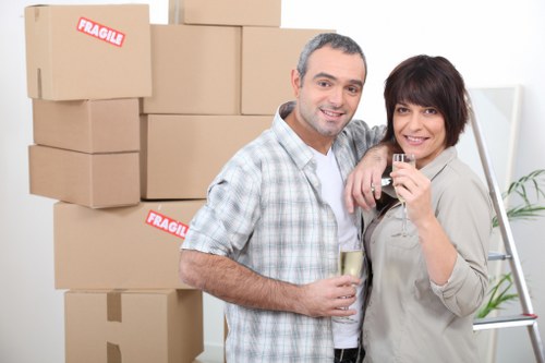 Professional movers protecting furniture during a flat removal job